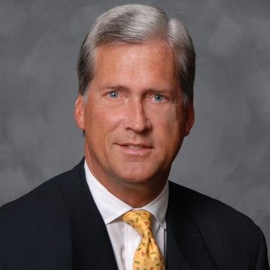 Robert P. Bruce, M.D., in a dark suit against a grey studio background