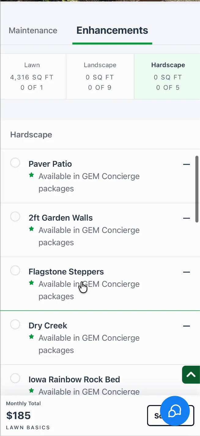 The Enhancements tab on a phone with the Hardscape tile selected: Paver Patio, 2ft Garden Walls, Flagstone Steppers, Dry Creek and Iowa Rainbow Rock Bed, each available in GEM Concierge packages.